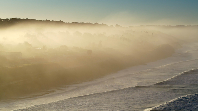 Southbound shot of marine layer with sun rays in Del Mar | Drone Video