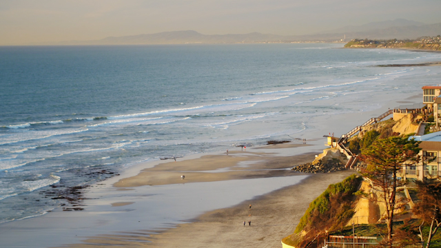 Panning golden hour shot of cliffside homes in Del Mar | Drone Video