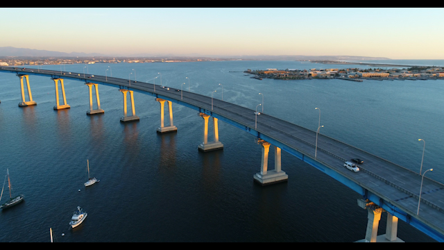 Aerial view of the harbor, the bridge and boats in Coronado, with boats out.