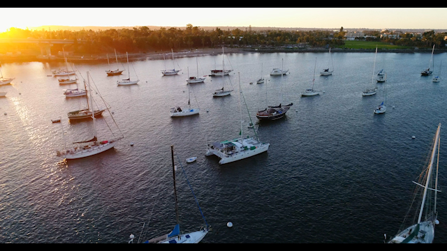 Low aerial view of the harbor, boats and the bay in Coronado, with boats out.