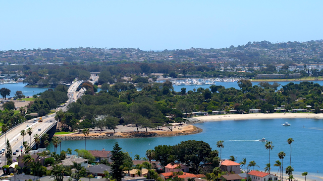 Aerial view of the harbor, the bridge and boats in Mission Bay, with boats out.