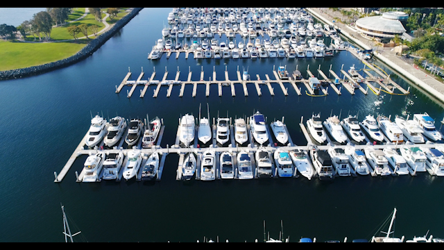 Aerial view of the harbor, boats and the bay in Downtown San Diego, with boats out.