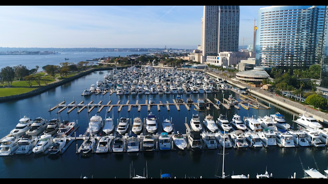 Aerial view of the harbor, the skyline and boats in Downtown San Diego, with boats out.