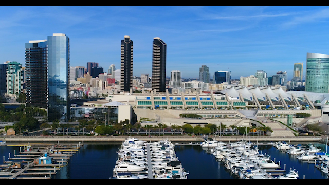 Low aerial view of the harbor, the skyline and boats in Downtown San Diego.