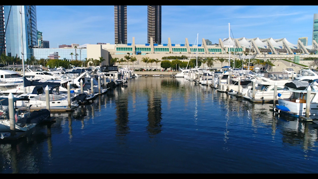 Low aerial view of the harbor, the skyline and boats in Downtown San Diego.