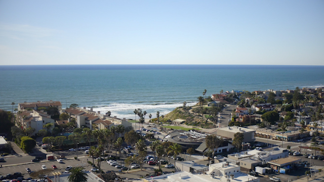 Aerial view of a residential street, the surf and palm trees in Solana Beach.
