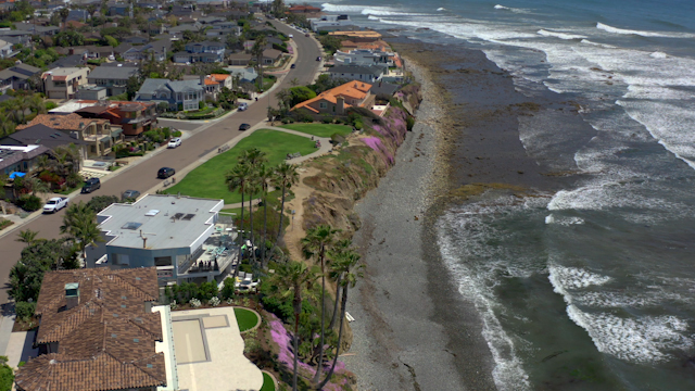 Aerial view of a residential street, the surf and palm trees at Bird Rock.