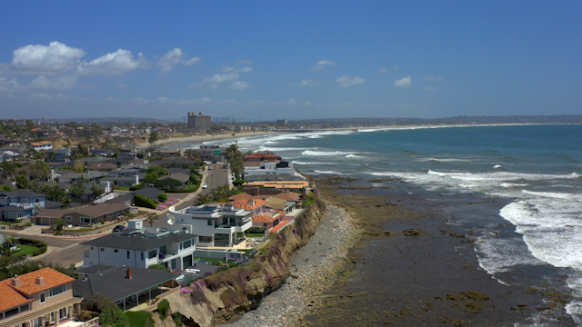 Aerial view of the cliffs, the surf and the pier at Bird Rock.