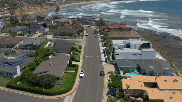 Aerial view of a residential street, the surf and the ocean at Bird Rock.
