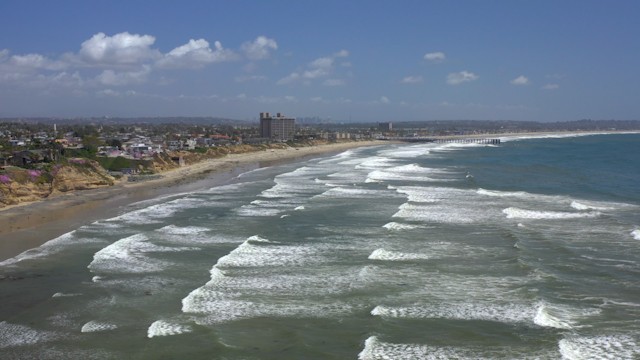 Aerial view of the beach, the surf and the pier at Bird Rock.