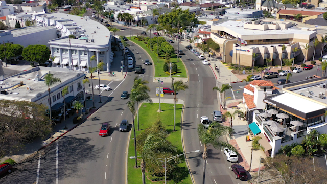 Low aerial view of the downtown streets, palm trees and homes in Coronado.
