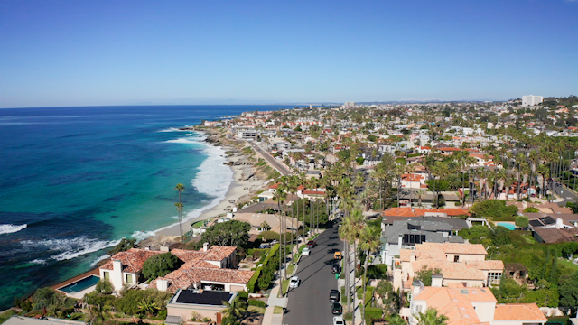 Aerial view of a residential street, the surf and palm trees at Windansea.