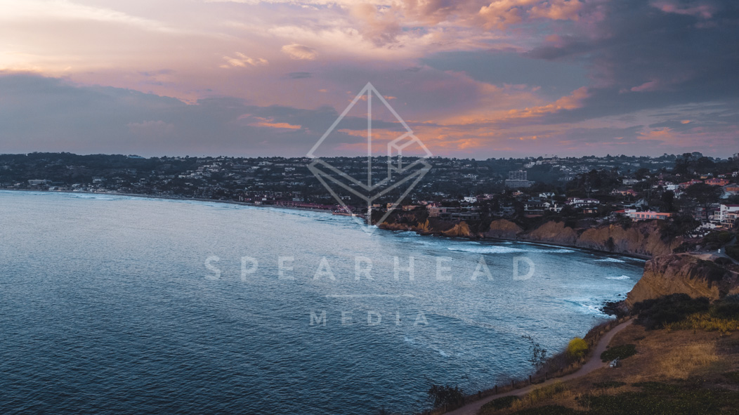Aerial view of the cliffs, the surf and the ocean at La Jolla Cove.