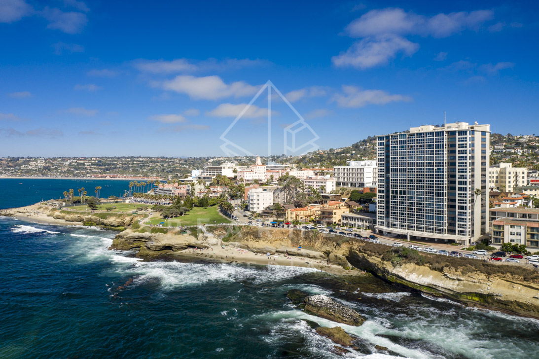 Aerial view of the cliffs, the surf and the ocean at La Jolla Cove.