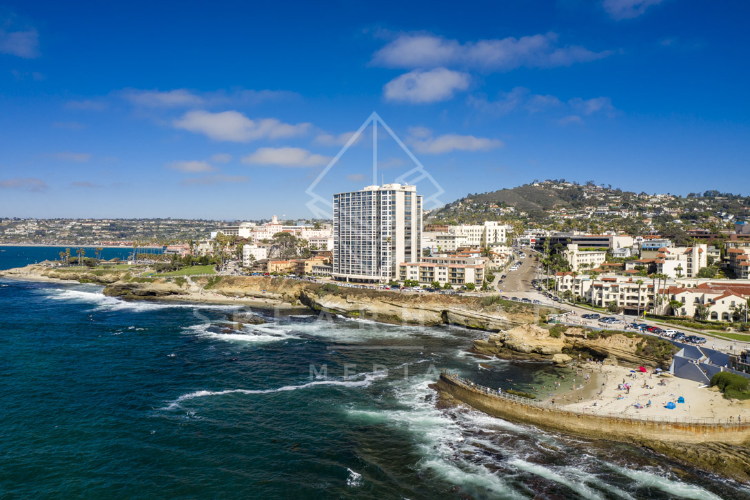 Aerial view of the cliffs, the surf and the ocean at La Jolla Cove.