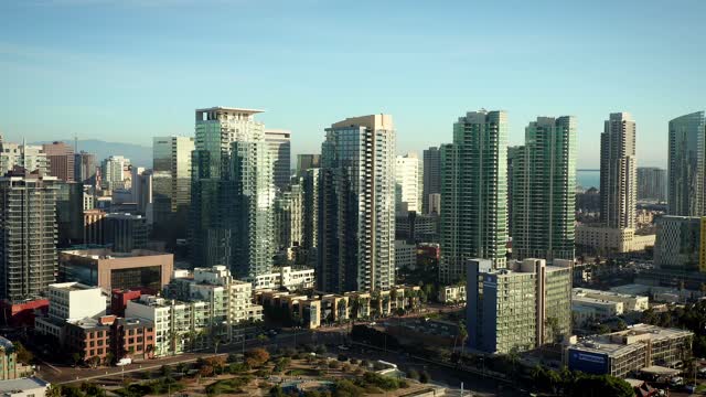 Low aerial view of the downtown streets, the skyline and homes at Waterfront.