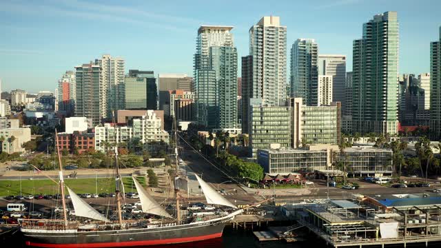 Low aerial view of the downtown streets, the skyline and boats at Waterfront.