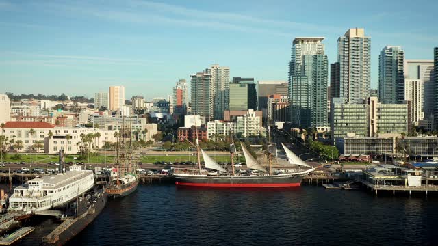Low aerial view of the harbor, the skyline and boats at Waterfront.