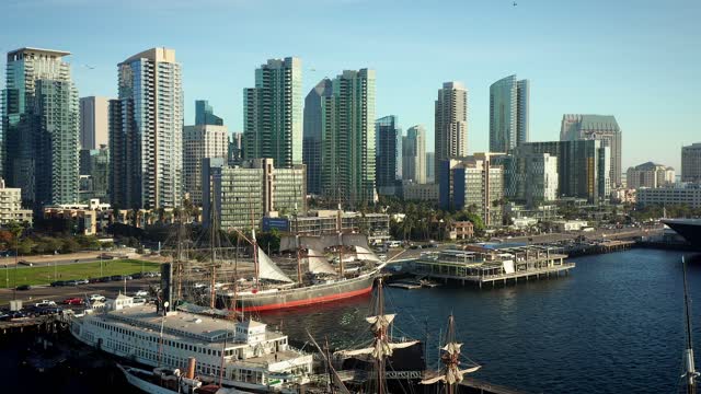 Low aerial view of the harbor, the skyline and boats at Waterfront.