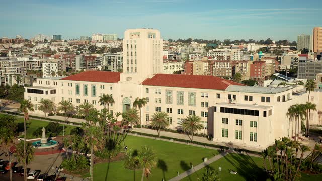 Low aerial view of the downtown streets, the skyline and palm trees at Waterfront.