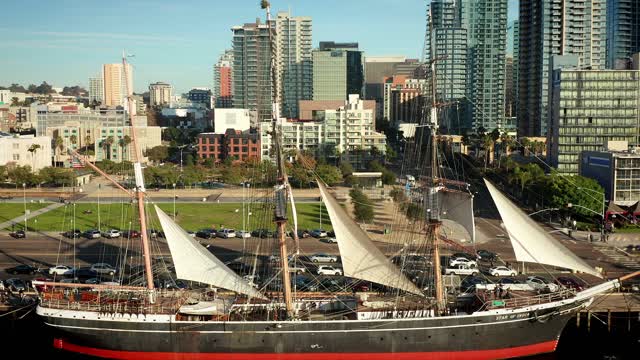 Low aerial view of the harbor, the skyline and boats at Waterfront.