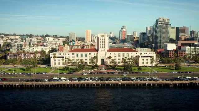 Low aerial view of the downtown streets, the skyline and palm trees at Waterfront.