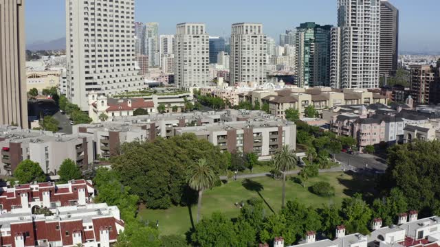 Low aerial view of the downtown streets, the skyline and palm trees at Gaslamp.