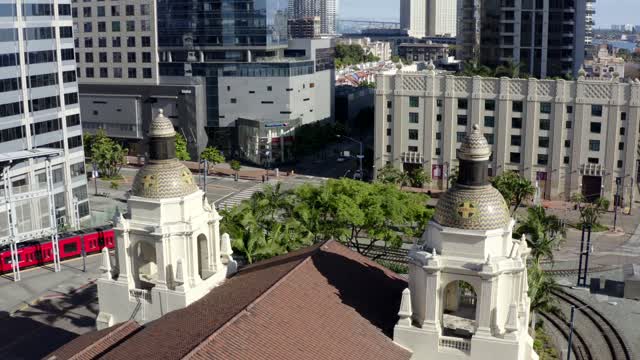 Low aerial view of the downtown streets, the skyline and palm trees at Waterfront.