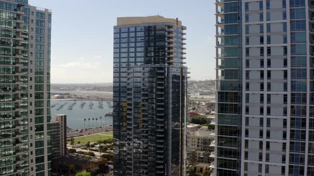 Low aerial view of the downtown streets, the skyline and boats at Waterfront.