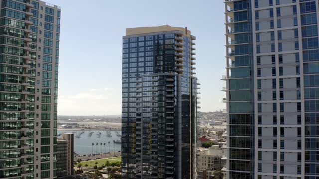 Low aerial view of the downtown streets, the skyline and boats at Waterfront.