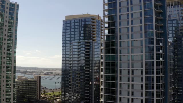 Low aerial view of the downtown streets, the skyline and boats at Waterfront.