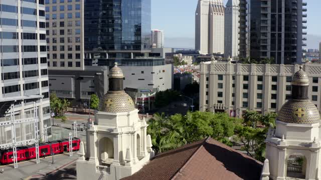 Low aerial view of the downtown streets, the skyline and palm trees at Waterfront.