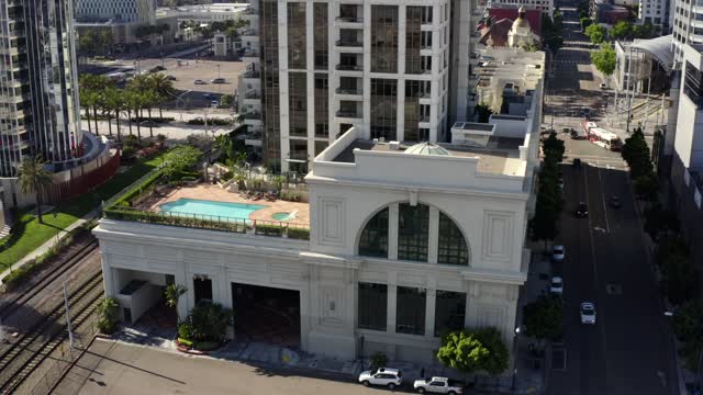 Low aerial view of the downtown streets, palm trees and homes at Waterfront.