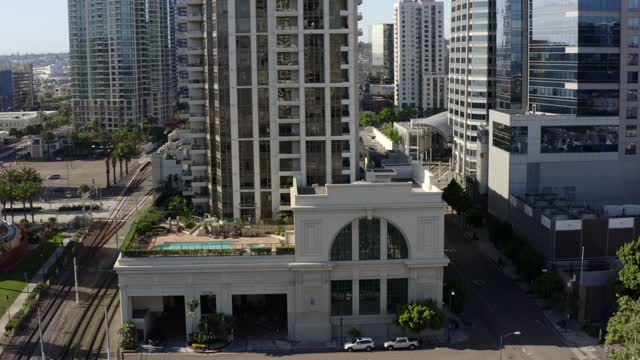 Low aerial view of the downtown streets, the skyline and palm trees at Waterfront.