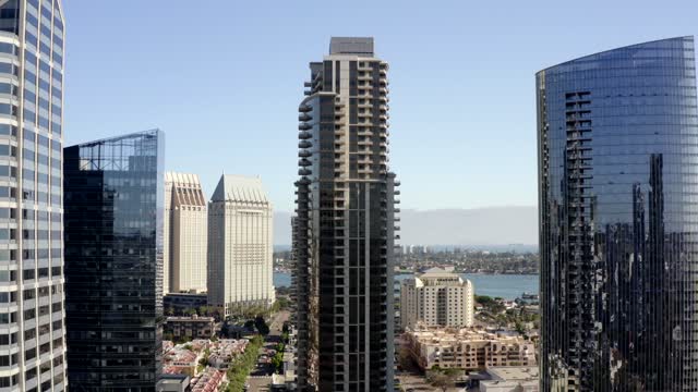 Low aerial view of the downtown streets, the skyline and the bay at Waterfront.