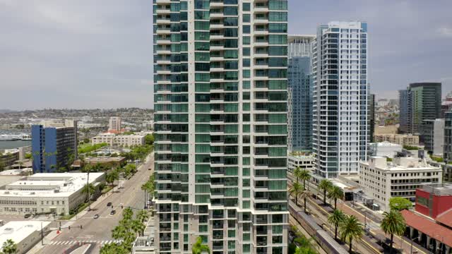 Low aerial view of the downtown streets, the skyline and palm trees at Waterfront.