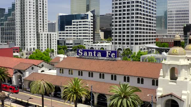 Low aerial view of the downtown streets, the skyline and palm trees at Waterfront.
