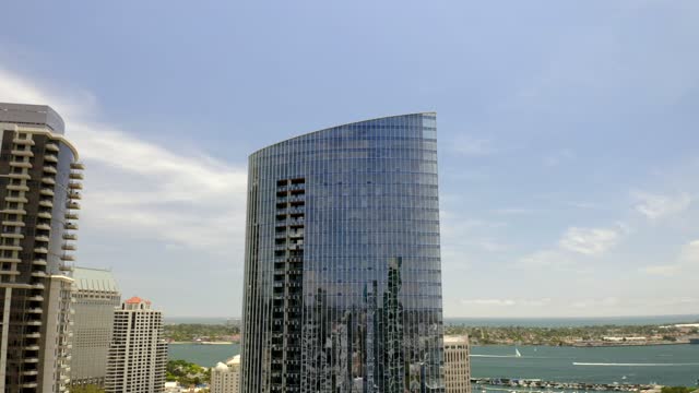 Low aerial view of the downtown streets, the skyline and boats at Waterfront.