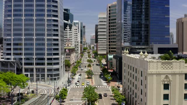 Low aerial view of the downtown streets, the skyline and palm trees at Gaslamp.