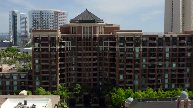 Low aerial view of the downtown streets, the skyline and palm trees at Marina.
