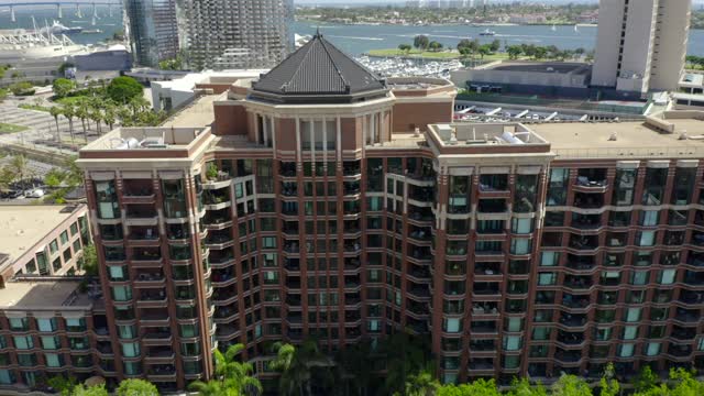 Low aerial view of the downtown streets, boats and palm trees at Marina.