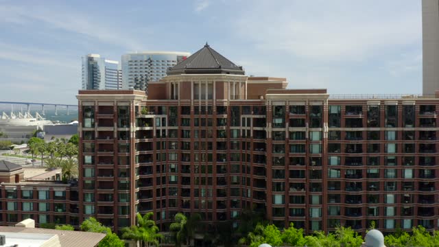 Low aerial view of the downtown streets, the skyline and palm trees at Marina.