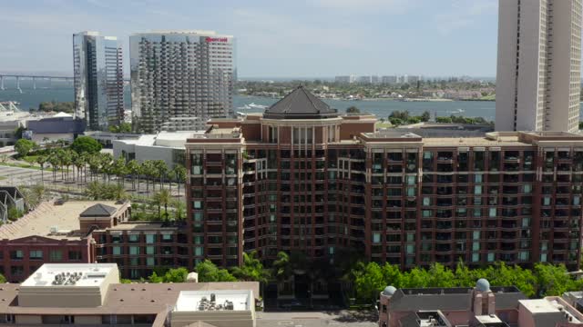 Low aerial view of the downtown streets, the skyline and boats at Marina.