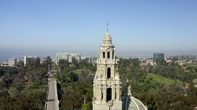 Low aerial view of a park, the bridge and the skyline in Balboa Park.
