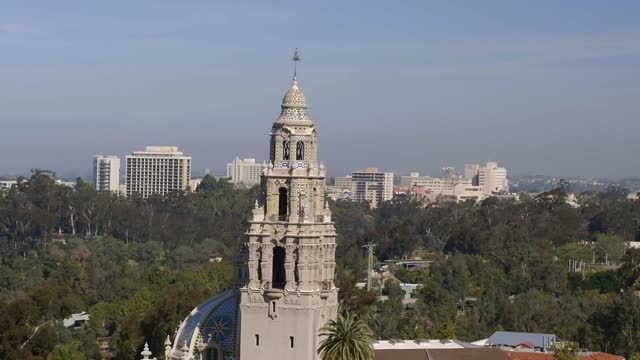 Low aerial view of a park, the skyline and the buildings in Balboa Park.