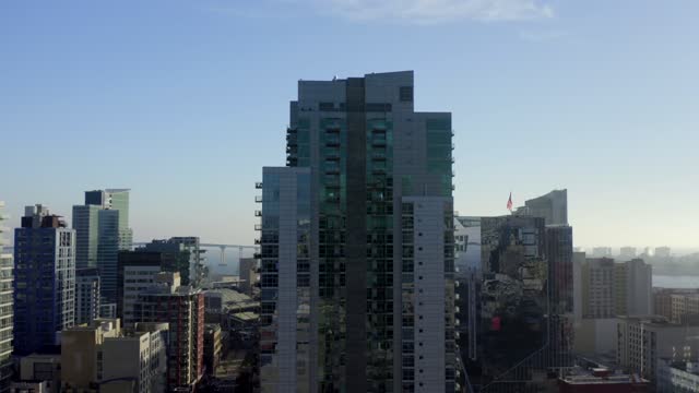 Low aerial view of the downtown streets, the bridge and the skyline at East Village.