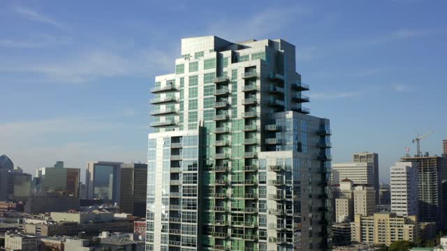 Low aerial view of the downtown streets, the skyline and the buildings at East Village.