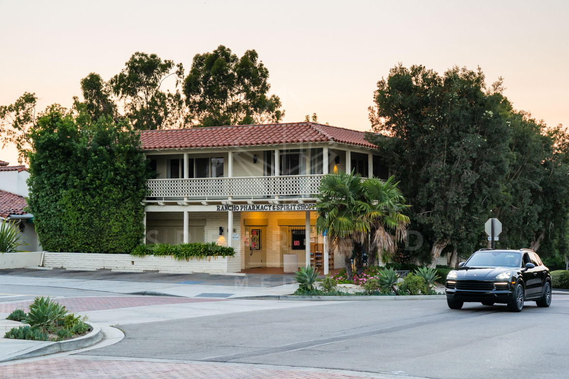 A residential street, palm trees and homes at Covenant.