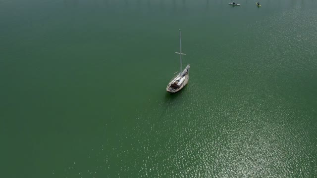 Aerial view of the beach, boats and the bay in Point Loma, with boats out.