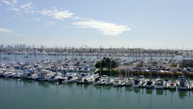 Low aerial view of the harbor, the skyline and boats in Point Loma, with boats out.